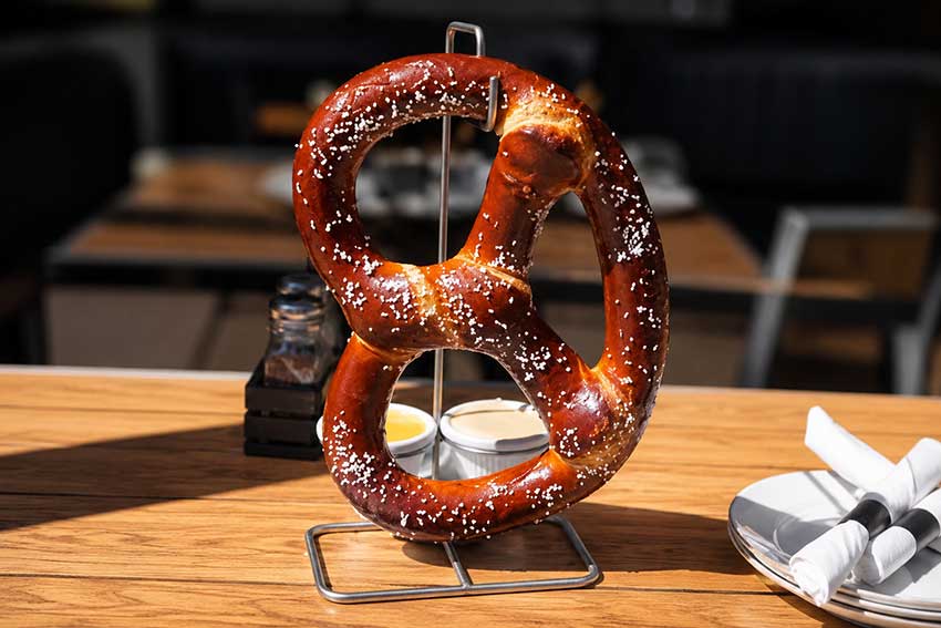 Warm pretzel with queso and honey mustard